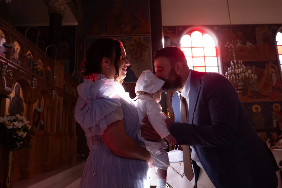 Family gathered inside church during an Orthodox christening in Melbourne