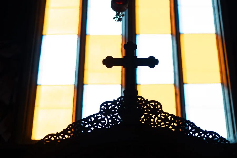 Church cross silhouette photographed during Orthodox christening coverage in Melbourne