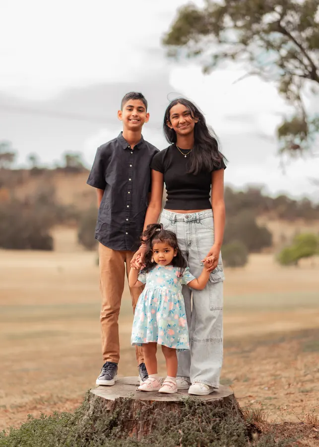 A warm family portrait taken in a sunlit park