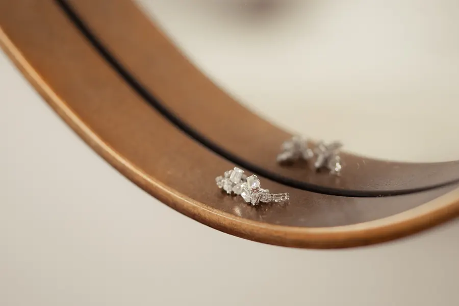 Wedding rings caught in a soft mirror reflection