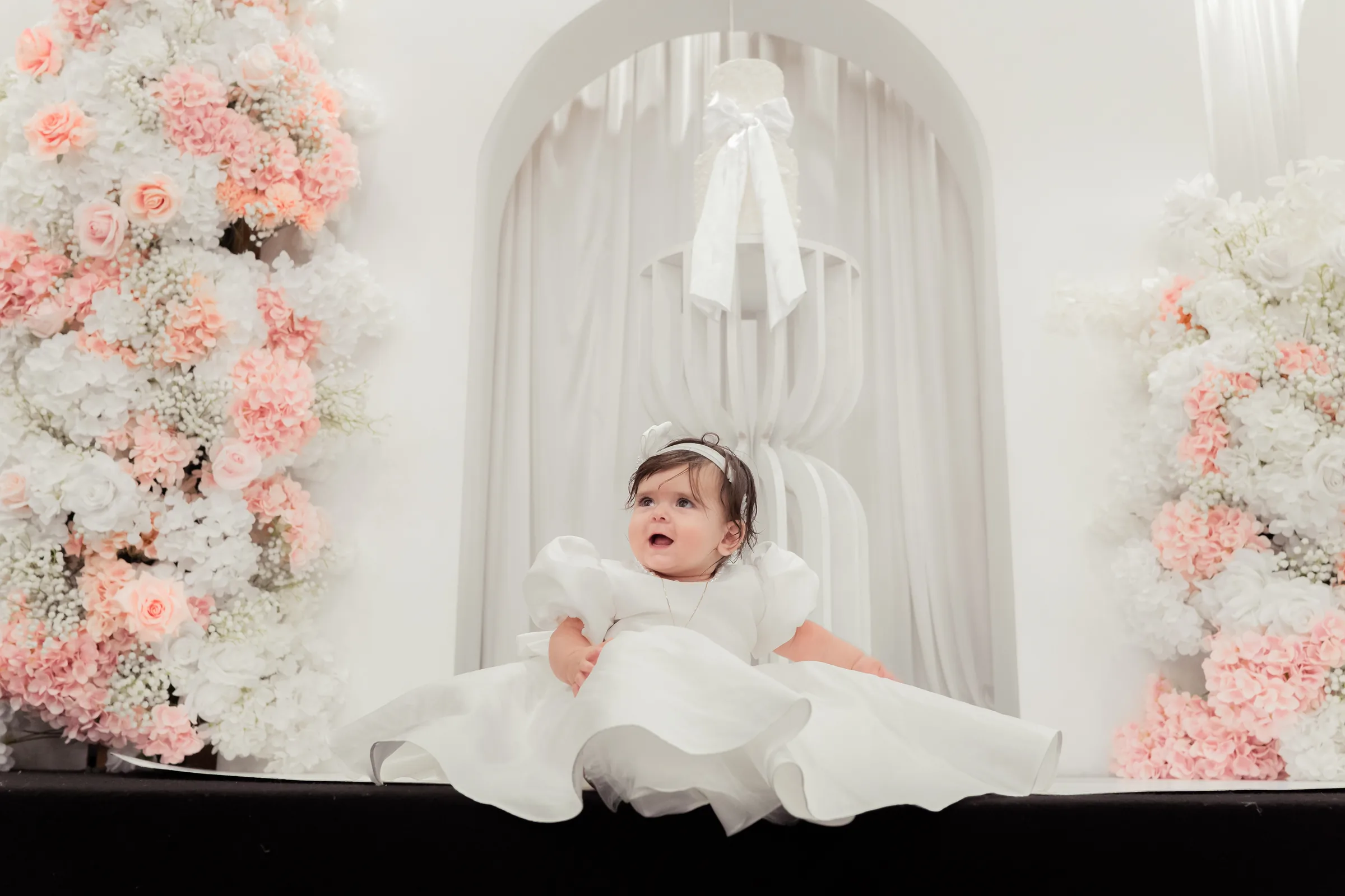 Baby portrait with floral christening styling at a Melbourne baptism reception