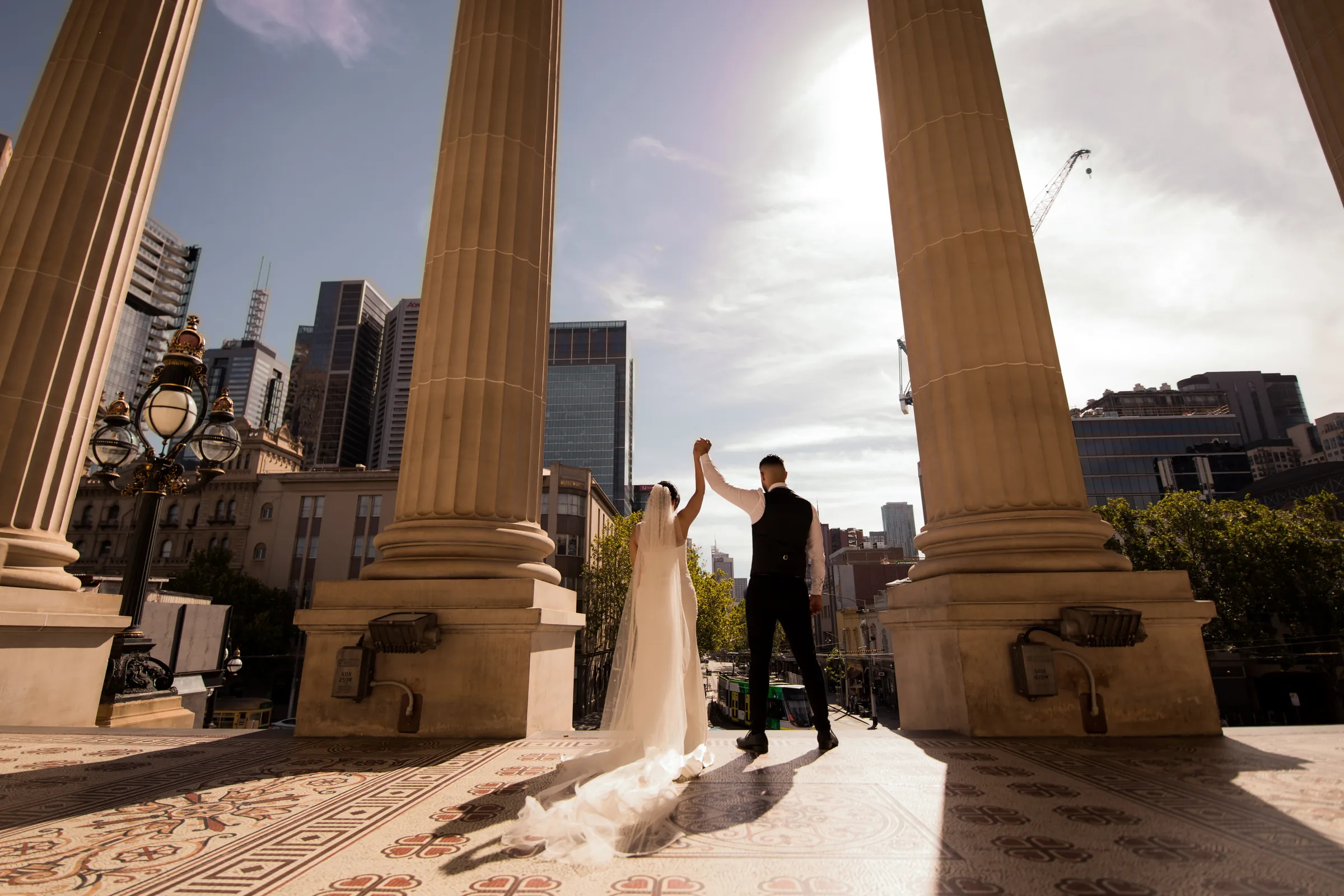 Wedding couple beneath Melbourne city arches photographed by Royale Photography