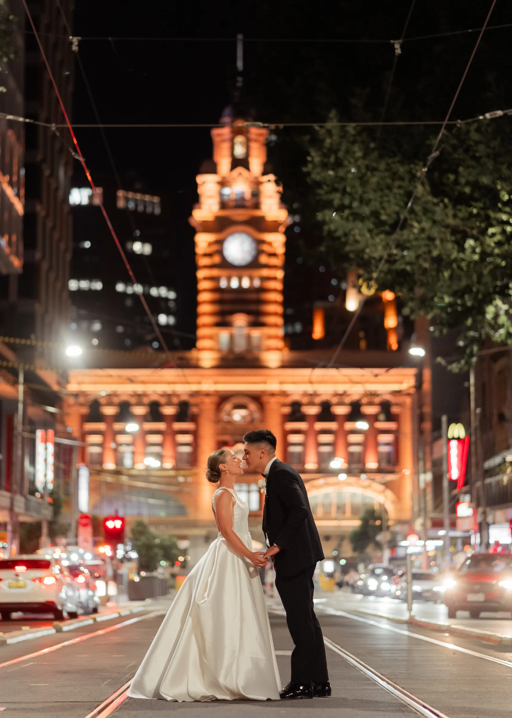 Wedding couple kissing on a city street at night photographed by Royale Photography